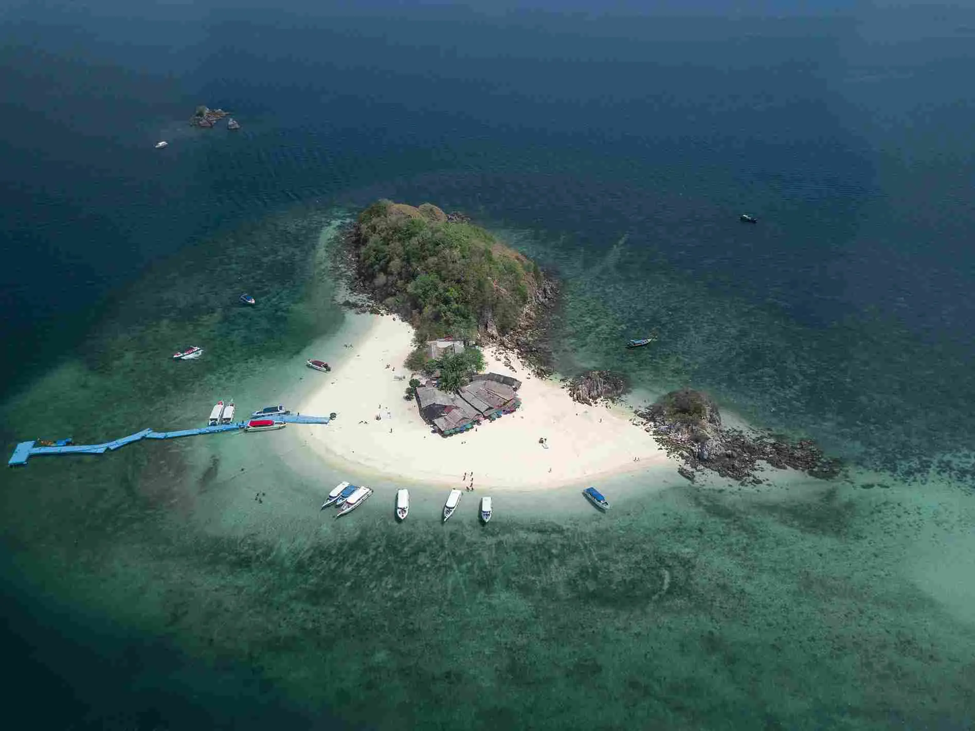 aerial-shot-small-island-with-few-buildings-boats-blue-dock_11zon.webp